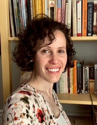 Michelle Radley Profile picture in front of bookshelf